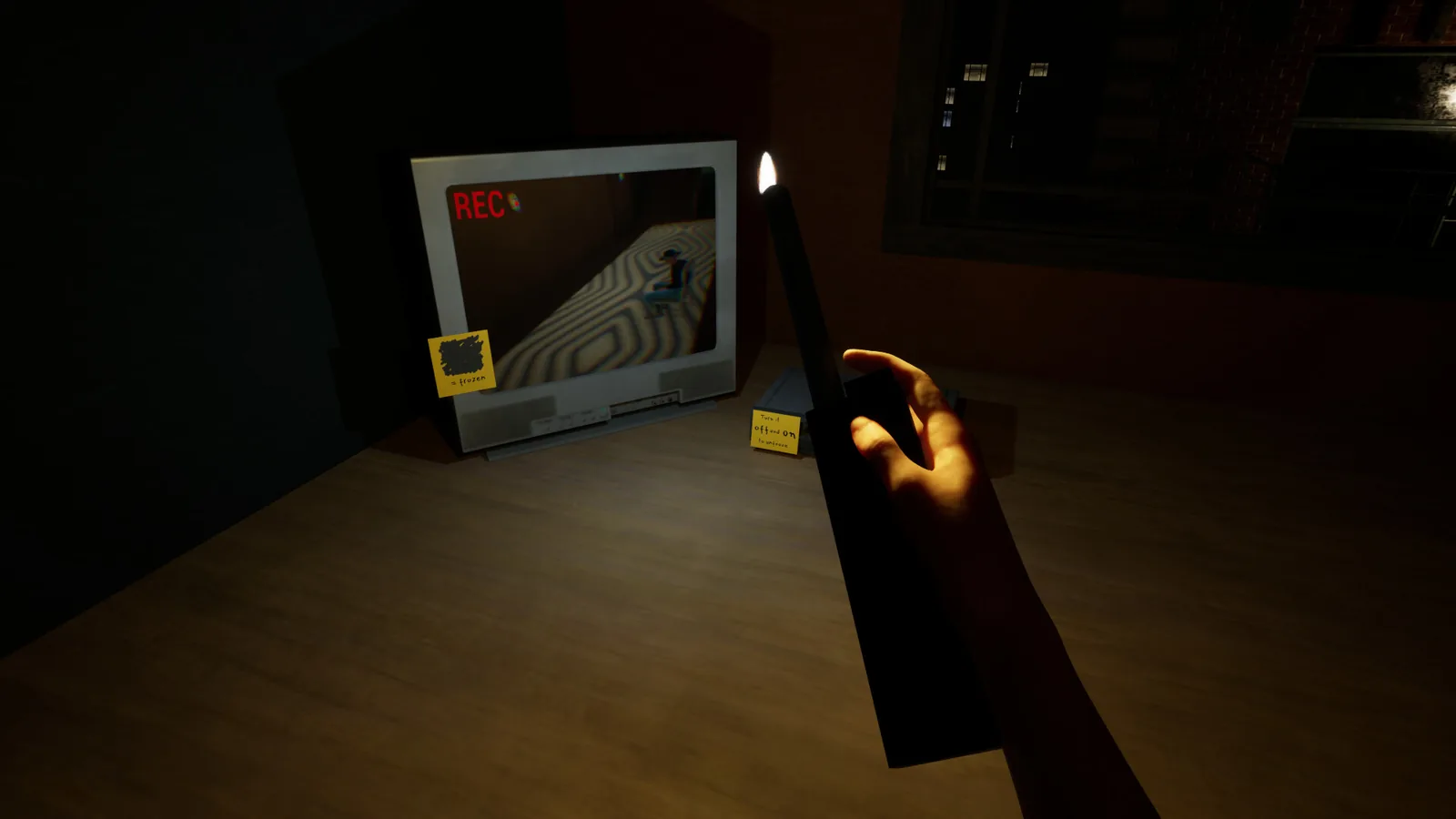 Holding a candle in front of a camera monitor showing REC